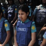 Bangladeshi police stand guard in front